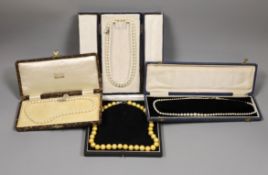 Four assorted cased single strand cultured pearl necklaces, with yellow metal or sterling clasps,