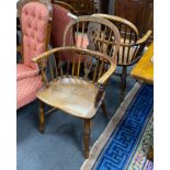 A pair of mid 19th century yew and elm Windsor elbow chairs, with crinoline stretchers, width