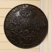 A Victorian cast iron shield shaped wall plaque,55cms diameter.