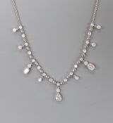 A modern 750 white metal and diamond cluster set drop fringe necklace, 42cm, gross weight 11.8