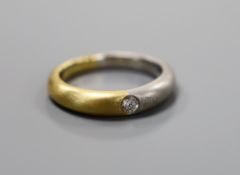 A modern sandblasted plat and 750 yellow metal ring, with gypsy set diamond, size M, gross weight