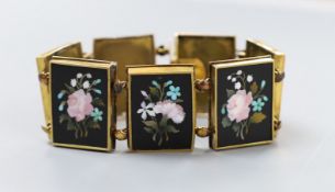 A 19th century Florentine yellow metal bracelet, set with seven pietra dura panels, decorated with