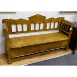 A 19th century Continental pine box seat settle with painted grain, width 190cm, depth 51cm,