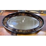 An early 20th century oval chinoiserie lacquered oval wall mirror, width 117cm, height 78cm