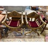 A pair of renaissance style giltwood and composition X frame elbow chairs, width 72cm, depth 51cm,