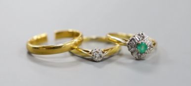 A 22ct yellow gold wedding band (cut), 3.5 grams together with two 18ct gold rings, emerald and