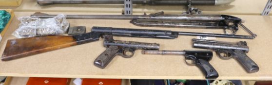 Two Webley air pistols, another, an air rifle and a part rifle