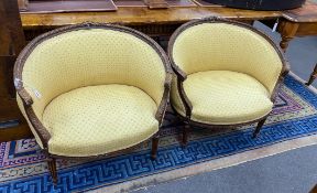 A pair of Louis XVI style carved beech upholstered tub framed chairs, width 82cm, depth 50cm, height