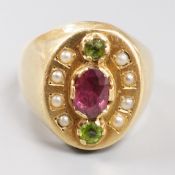 A gold (tests as 18ct), three stone two colour garnet and split pearl cluster set oval dress ring,