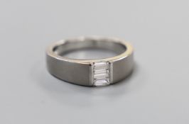 A modern sandblasted platinum and the stone baguette cut diamond set ring, size P/Q, gross weight
