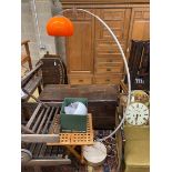 A 1960's adjustable chromium arc floor lamp with orange shade, height 175cm and a spare white shade