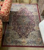 A Persian style burgundy ground machined rug, 196 x 137cm