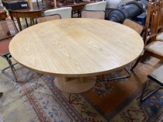 A Conran retailed circular pale ash dining table, on three pillars and circular plinth foot,