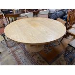 A Conran retailed circular pale ash dining table, on three pillars and circular plinth foot,