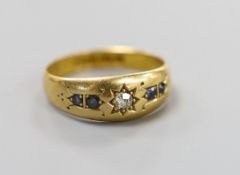 A late Victorian 18ct gold, single stone diamond and four stone sapphire gypsy set ring, size N,