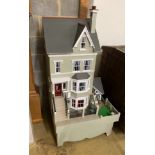 A good quality modern painted wood doll's house, modelled as a Victorian four storey villa, width