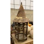 An Eastern wood bird house (?), diameter 47cm, height 130cm