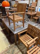 A weathered teak square garden table, width 80cm, height 73cm together with two teak elbow chairs