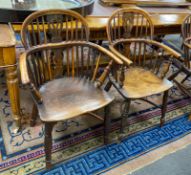 A near pair of mid 19th century yew and elm Windsor elbow chairs, with crinoline stretchers,