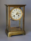 A 19th century French four glass mantel clock, with key and pendulum, 27cms high