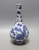 A Chinese blue and white ‘dragon and phoenix’ bottle vase, 23 cms high.