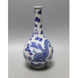 A Chinese blue and white ‘dragon and phoenix’ bottle vase, 23 cms high.