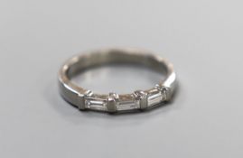 A modern platinum and end set three stone baguette cut diamond ring, size N, gross weight 4.2 grams,
