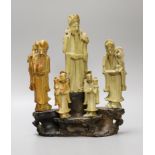 A Chinese soapstone five immortals group on graduated base, 28cm tall