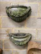 A pair of reconstituted stone garden wall planters, width 45cm, height 24cm