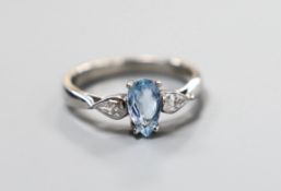 A modern platinum, pear cut aquamarine and two stone pear cut diamond set dress ring, size N,