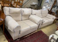 Two cream upholstered settees, with blue corded edging, larger length 200cm, depth 100cm, height