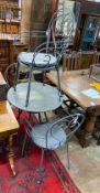 A circular wrought iron garden table, diameter 70cm, height 71cm together with four wrought iron