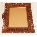 A Chinese carved sandalwood picture frame, 36x41 cm total