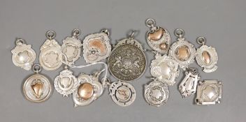 Fifteen assorted silver prize medallions, some with gold overlay, gross 113 grams, and a Madras