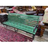 A wrought iron painted slatted wood garden bench, length 213cm, width 70cm, height 86cm