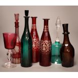 A pair of cut ruby flashed glass decanters, late Georgian emerald green glass decanter, and four