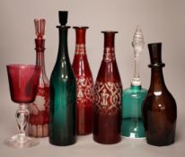 A pair of cut ruby flashed glass decanters, late Georgian emerald green glass decanter, and four