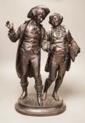 A black patinated spelter group, two 18th century figures in conversation, 48cm tall