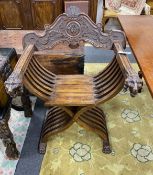 An Italian carved walnut folding Savaranola type elbow chair, width 66cm, depth 51cm, height 92cm