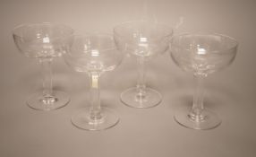 A set of four facet cut hollow stemmed champagne glasses