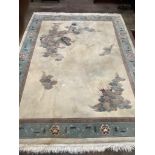 A Chinese gold ground carpet woven with dragon and flaming pearl motif within a geometric floral