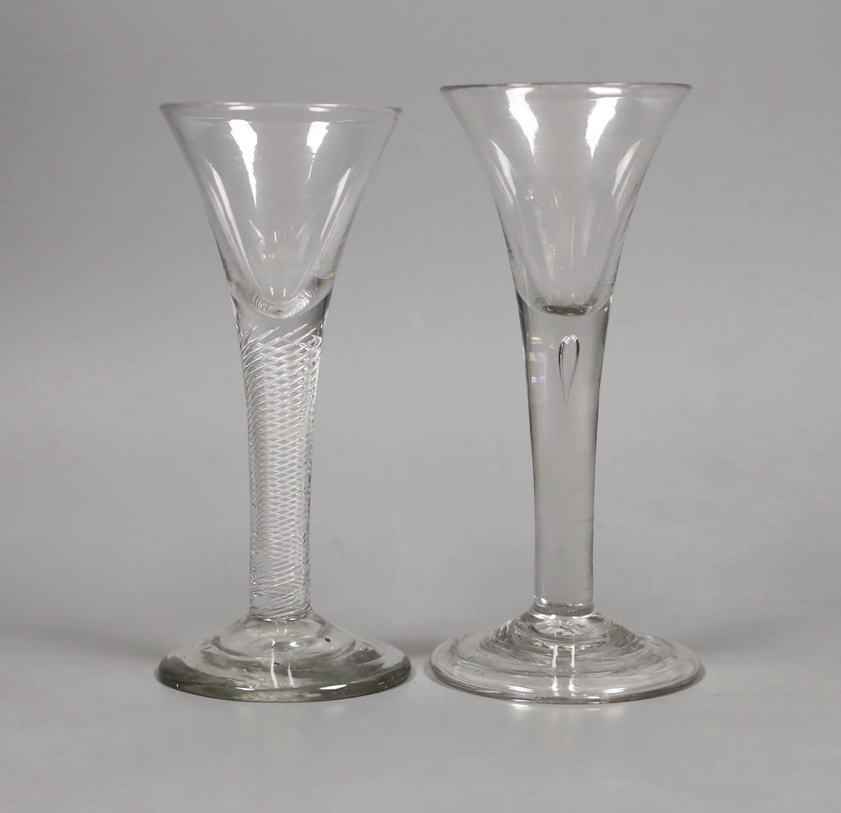 Two 18th century drawn trumpet wine glasses, one with air twist stem, tallest 15.5cm