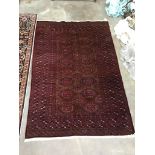 A Bokhara red ground carpet, 230cm x 152cm
