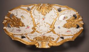 An early 20th century Meissen two handled white and gilt floral oval dish, 32cm