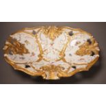 An early 20th century Meissen two handled white and gilt floral oval dish, 32cm