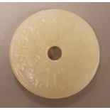 A Chinese pale celadon jade bi disc