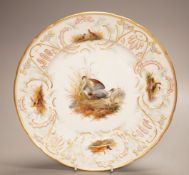 A late 19th century Meissen porcelain plate, painted with herons and game birds amid grass, diameter