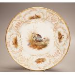 A late 19th century Meissen porcelain plate, painted with herons and game birds amid grass, diameter