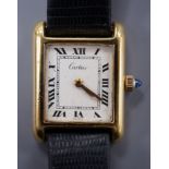 A ladies gold plated Cartier tank wrist watch, with cabochon set winder