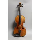 A 19th century violin labelled JB Guadagnini, back measures 35cm, with two bows, one silver-mounted.